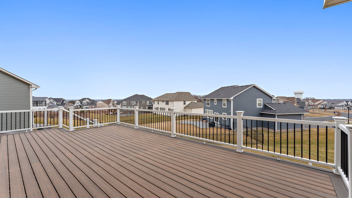 Composite decking boards and railing on a deck in winter, showing the surface texture.
