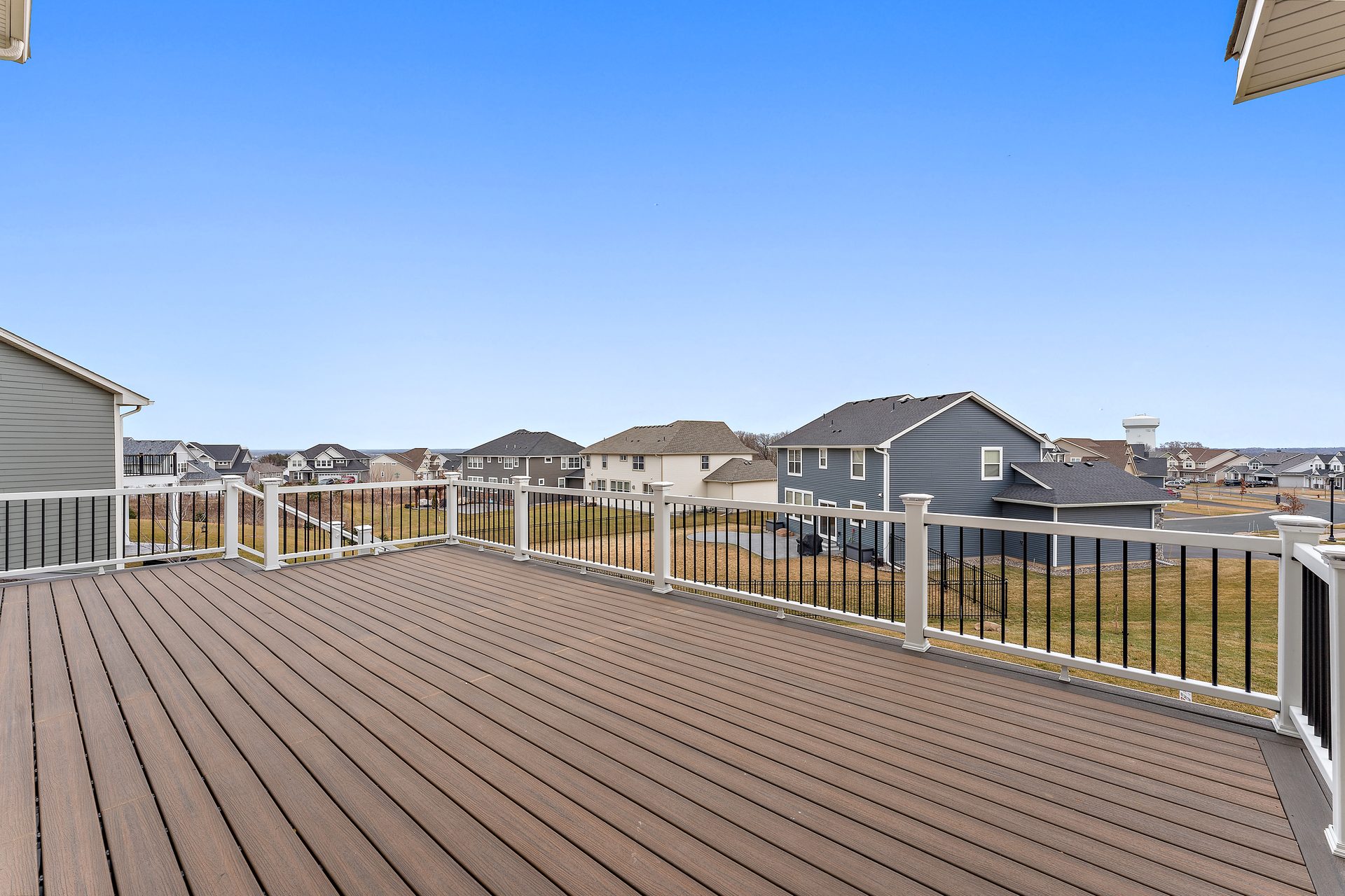 Composite deck with a black metal guard, looking out over open ground