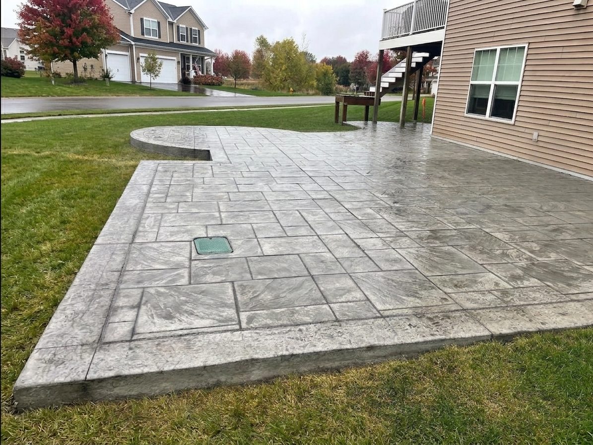 Stamped concrete patio with a tooled border, laid to a lawn edge