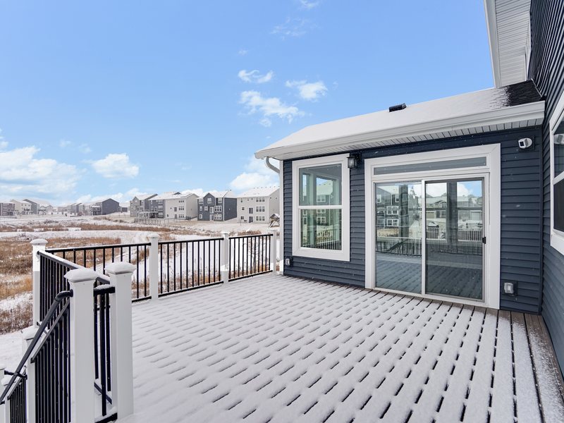 Composite decking and black metal balusters on a raised deck.