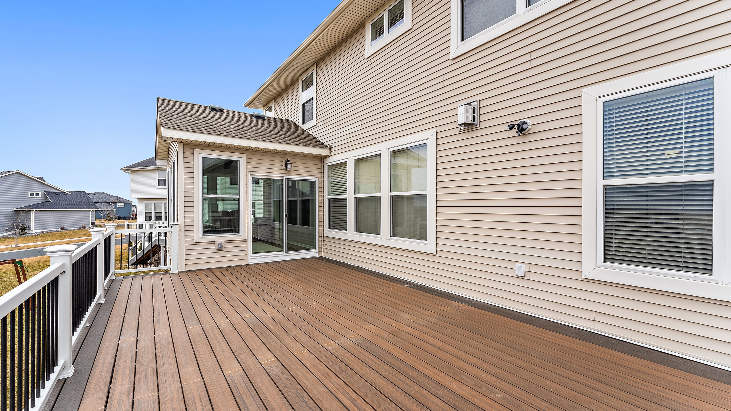 A composite deck with an aluminum guard overlooking an open back yard in the Twin Cities.